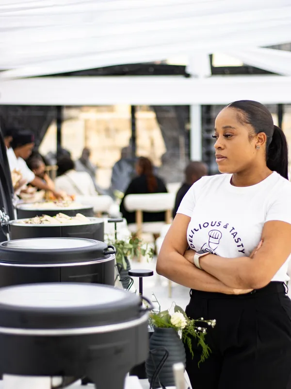 MaShandu in a Delicious and Tasty T-shirt beside black roll-top chafers